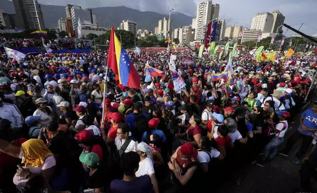 Supporters of President Nicolas Maduro attend his closing election campaign rally in Caracas, Venezuela, Thursday, July 25, 2024. Maduro is seeking re-election for a third term in the July 28 vote. (AP Photo/Fernando Vergara)