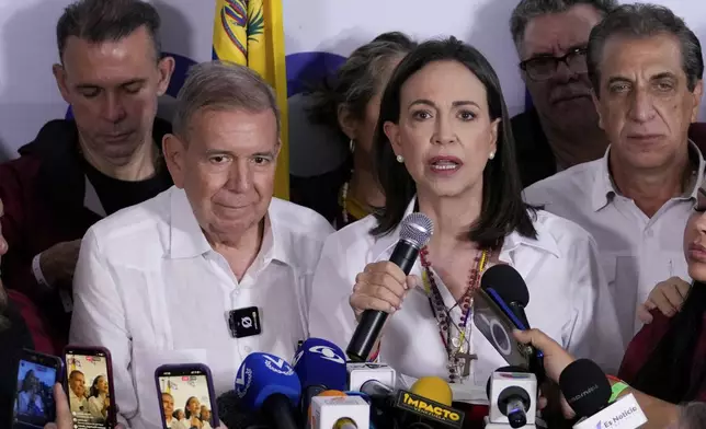 Opposition leader Maria Corina Machado, right, and presidential candidate Edmundo Gonzalez hold a press conference after electoral authorities declared President Nicolas Maduro the winner of the presidential election in Caracas, Venezuela, Monday, July 29, 2024. (AP Photo/Matias Delacroix)