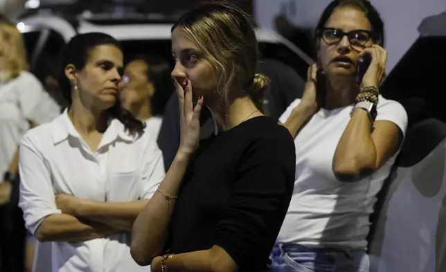 Supporters of opposition candidate Edmundo Gonzalez gather outside his campaign headquarters after the polls closed for the presidential election in Caracas, Venezuela, Sunday, July 28, 2024. (AP Photo/Cristian Hernandez)