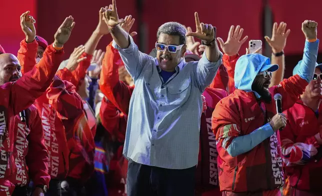 President Nicolas Maduro gestures to the crowd during his closing election campaign rally in Caracas, Venezuela, Thursday, July 25, 2024. Maduro is seeking re-election for a third term in the July 28 vote. (AP Photo/Fernando Vergara)