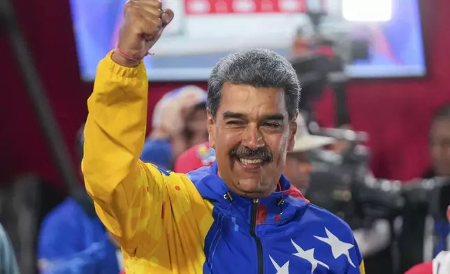 President Nicolas Maduro addresses supporters after electoral authorities declared him the winner of the presidential election in Caracas, Venezuela, Monday, July 29, 2024. (AP Photo/Fernando Vergara)