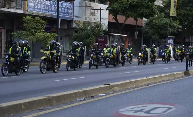 Police patrol the streets during the presidential election in Caracas, Venezuela, Sunday, July 28, 2024. (AP Photo/Fernando Vergara)