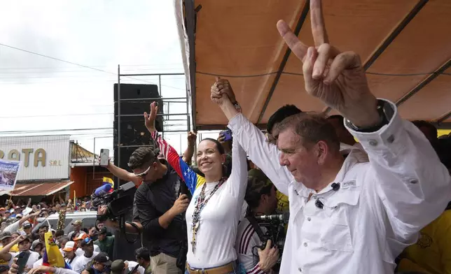 Opposition leader Maria Corina Machado and presidential candidate Edmundo Gonzalez greet supporters at his campaign rally in Barinas, Venezuela, Saturday, July 6, 2024. (AP Photo/Ariana Cubillos)