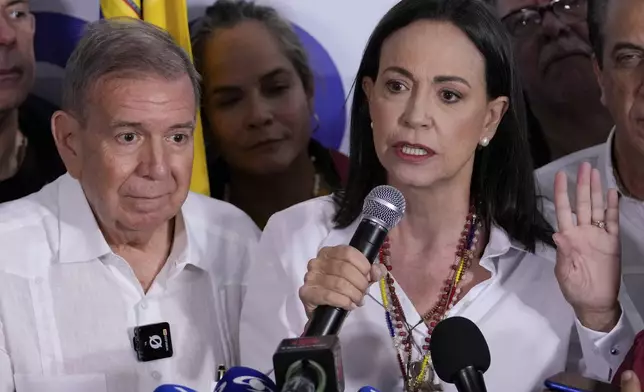 Opposition leader Maria Corina Machado, right, and presidential candidate Edmundo Gonzalez hold a press conference after electoral authorities declared President Nicolas Maduro the winner of the presidential election in Caracas, Venezuela, Monday, July 29, 2024. (AP Photo/Matias Delacroix)