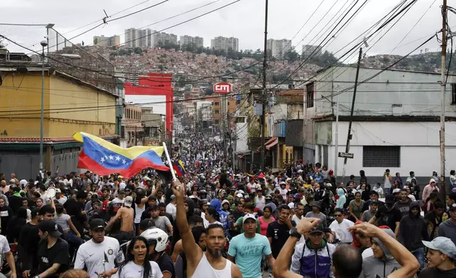 Protesters demonstrate against the official election results declaring President Nicolas Maduro won reelection in the Catia neighborhood of Caracas, Venezuela, Monday, July 29, 2024, the day after the vote. (AP Photo/Cristian Hernandez)