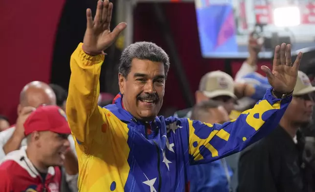 President Nicolas Maduro addresses supporters gathered outside the Miraflores presidential palace after electoral authorities declared him the winner of the presidential election in Caracas, Venezuela, Monday, July 29, 2024. (AP Photo/Fernando Vergara)