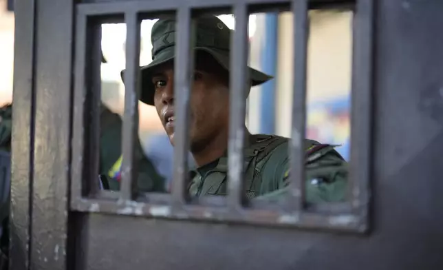 A soldier guards the entrance of an open voting center during the presidential election in Caracas, Venezuela, Sunday, July 28, 2024. (AP Photo/Fernando Vergara)