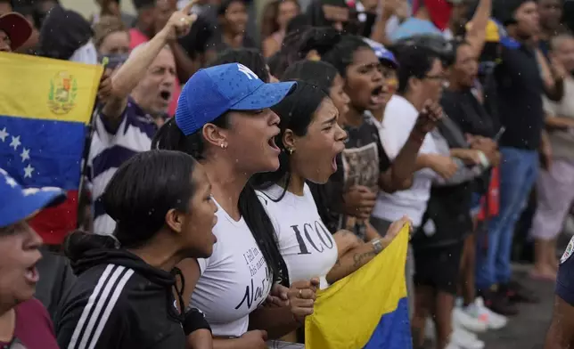 Residents block a street to protest the official results the day after the presidential election in Caracas, Venezuela, Monday, July 29, 2024. (AP Photo/Fernando Vergara)