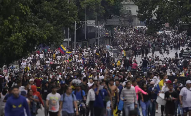 Protesters demonstrate against the official election results declaring President Nicolas Maduro the winner, the day after the presidential election in Caracas, Venezuela, Monday, July 29, 2024. (AP Photo/Matias Delacroix)