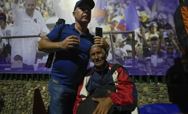 Supporters of opposition presidential candidate Edmundo Gonzalez embrace after electoral authorities declared President Nicolas Maduro winner of the presidential election in Caracas, Venezuela, Monday, July 29, 2024. (AP Photo/Matias Delacroix)