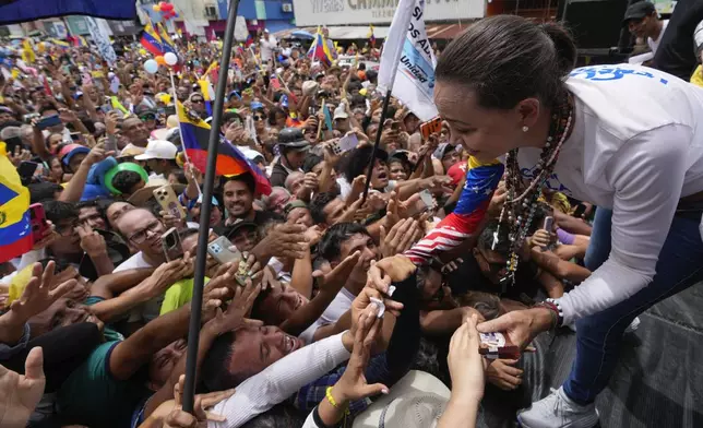 Opposition leader Maria Corina Machado greets supporters at a campaign rally for presidential candidate Edmundo Gonzalez, in Barinas, Venezuela, Saturday, July 6, 2024. (AP Photo/Ariana Cubillos)