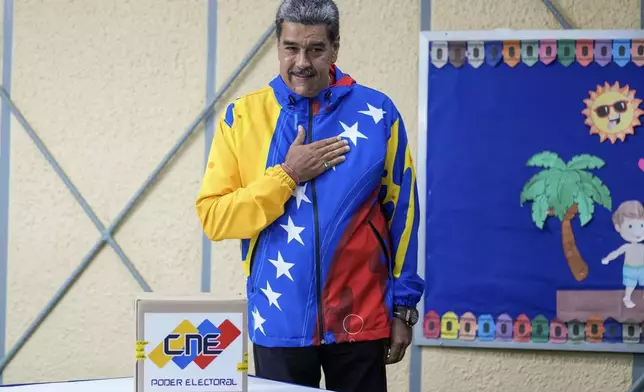 President Nicolas Maduro gestures after casting his ballot during presidential elections in Caracas, Venezuela, Sunday, July 28, 2024. Maduro is seeking re-election for a third term. (AP Photo/Fernando Vergara)