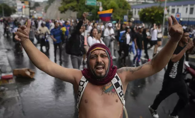 People protest the official results declaring President Nicolas Maduro was reelected, the day after the vote in Caracas, Venezuela, Monday, July 29, 2024. (AP Photo/Fernando Vergara)