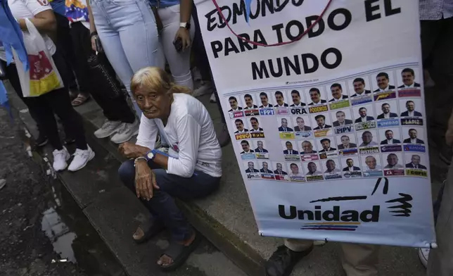 A supporter of opposition presidential candidate Edmundo Gonzalez holds a poster featuring the presidential ballot as thousands wait for his arrival at a campaign rally in Barinas, Venezuela, Saturday, July 6, 2024. The official campaign period for the July 28 election kicked off on July 4. (AP Photo/Ariana Cubillos)