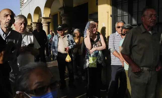 Voters line up at a polling center during presidential elections in Caracas, Venezuela, Sunday, July 28, 2024. (AP Photo/Matias Delacroix)