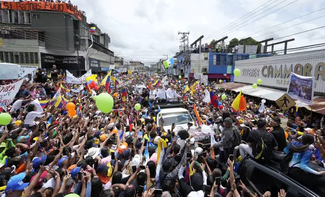 Venezuelan presidential candidate Edmundo Gonzalez and opposition leader Maria Corina Machado parade on a truck transporting them through a crowd of supporters during a campaign rally in Barinas, Venezuela, Saturday, July 6, 2024. (AP Photo/Ariana Cubillos)