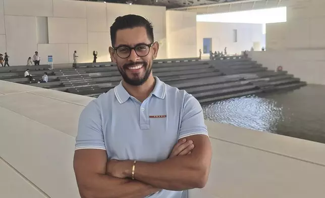 Venezuelan José Alberto Morán poses for a photo during a visit to Louvre Museum in Abu Dhabi, United Arab Emirates, in December 2022. Morán, who was studying and working in Caracas, moved to Valencia in 2016, becoming the first member of his family to leave. (Courtesy of Jose Moran Dorante via AP)