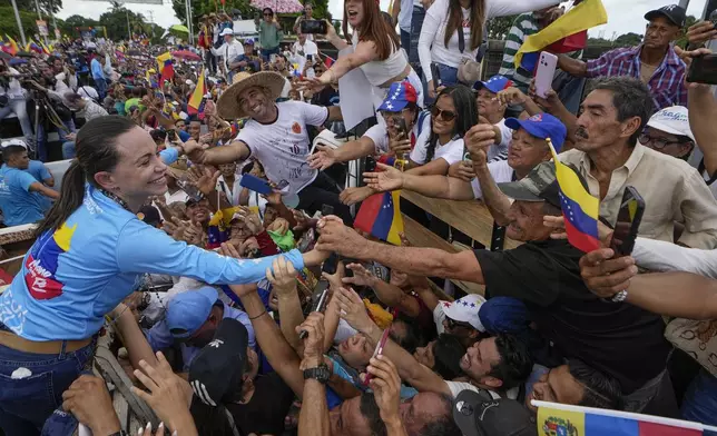 Opposition leader Maria Corina Machado greets supporters during a campaign rally for presidential candidate Edmundo Gonzalez, in Maturin, Venezuela, Saturday, July 20, 2024. The presidential election is set for July 28. (AP Photo/Matias Delacroix)