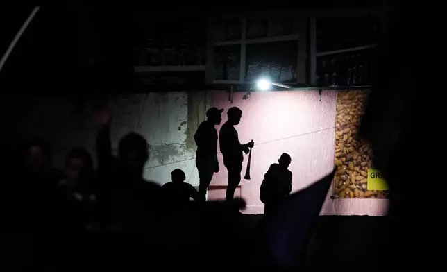 Opposition supporters watch a campaign rally for presidential candidate Edmundo Gonzalez and opposition leader Maria Corina Machado in Maracaibo, Venezuela, Tuesday, July 23, 2024. The presidential election is set for July 28. (AP Photo/Matias Delacroix)