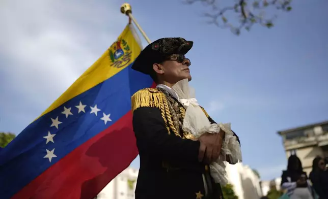 A man dressed as an Independence fighter attends a campaign event with opposition presidential candidate Edmundo Gonzalez in Caracas, Venezuela, Thursday, June 13, 2024. Venezuela is set to hold its presidential election on July 28. (AP Photo/Ariana Cubillos)