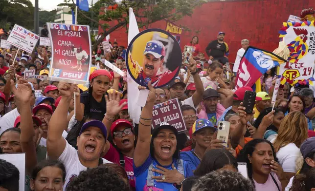 Supporters of Venezuelan President Nicolas Maduro attend at a campaign rally in the Catia neighborhood of Caracas, Venezuela, Thursday, July 18, 2024. Venezuela is set to hold presidential elections July 28. (AP Photo/Matias Delacroix)