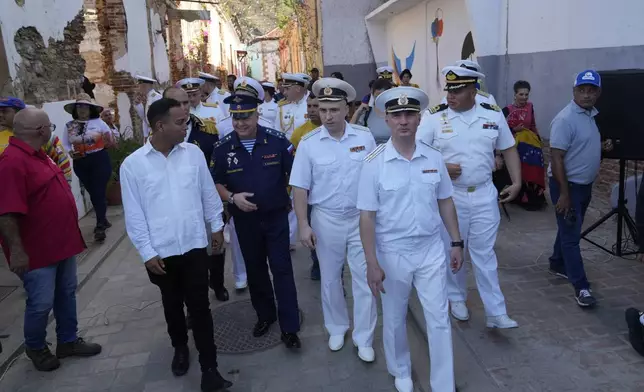 Russian crew members attend a welcoming tour by official authorities in La Guaira, Venezuela, after the Almirante Gorshkov frigate and Akademik Pashin oil tanker of the Russian Navy docked there, Tuesday, July 2, 2024. (AP Photo/Ariana Cubillos)