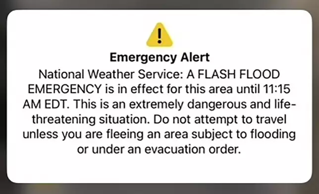 In this screen shot of a National Weather Service alert for a flash flood emergency is shown on a phone near St. Johnsbury, Vt., Tuesday, July 30, 2024. Heavy rain has washed out some roads and led to about two dozen rescues in northern Vermont, nearly three weeks after many farmers and residents in the state were hit by flooding from the remnants of Hurricane Beryl. (AP Photo/Lisa Rathke)