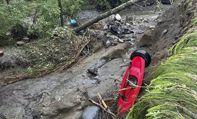 Damage from flash floods is seen on Tuesday, July 30, 2024, in St. Johnsbury, Vt. Heavy rain has washed out some roads and led to about two dozen rescues in northern Vermont, nearly three weeks after many farmers and residents in the state were hit by flooding from the remnants of Hurricane Beryl. (Vanessa Allen via AP)