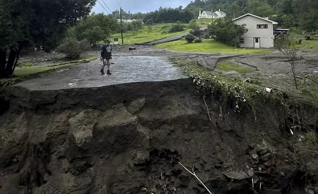 Damage from flash floods are seen on Tuesday, July 30, 2024, in St. Johnsbury, Vt. Heavy rain has washed out some roads and led to about two dozen rescues in northern Vermont, nearly three weeks after many farmers and residents in the state were hit by flooding from the remnants of Hurricane Beryl. (Vanessa Allen via AP)