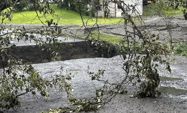 Damage from flash floods is seen on Tuesday, July 30, 2024, in St. Johnsbury, Vt. Heavy rain has washed out some roads and led to about two dozen rescues in northern Vermont, nearly three weeks after many farmers and residents in the state were hit by flooding from the remnants of Hurricane Beryl. (Vanessa Allen via AP)