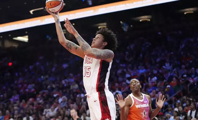 Brittney Griner, left, of Team USA, gets past Nneka Ogwumike, right, of Team WNBA, to score during the first half of a WNBA All-Star basketball game Saturday, July 20, 2024, in Phoenix. (AP Photo/Ross D. Franklin)