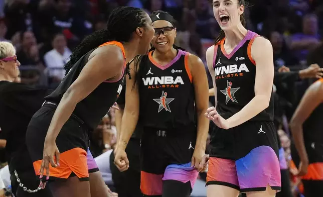 Caitlin Clark, right, Allisha Gray, center, and Aliyah Boston, left, of Team WNBA, celebrate a made 3-point basket by a teammate against Team USA during the second half of a WNBA All-Star basketball game Saturday, July 20, 2024, in Phoenix. (AP Photo/Ross D. Franklin)