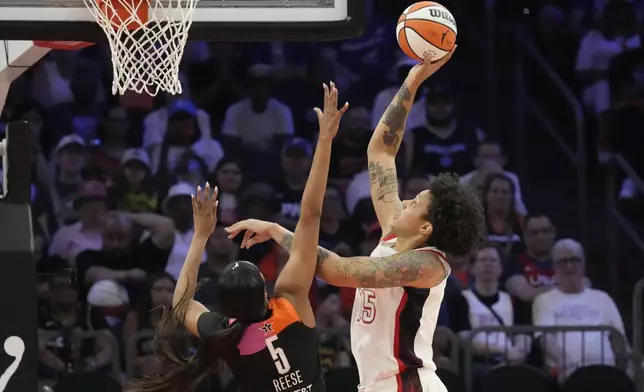 Brittney Griner (15), of Team USA, shoots over Angel Reese (5), of Team WNBA, during the second half of a WNBA All-Star basketball game Saturday, July 20, 2024, in Phoenix. (AP Photo/Ross D. Franklin)