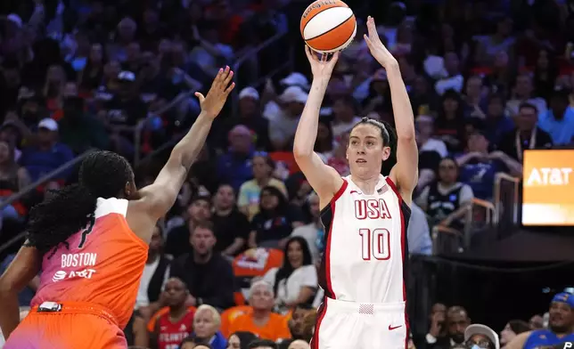 Breanna Stewart (10), of Team USA, looks to shoot a 3-point basket over Aliyah Boston, of Team WNBA, during the first half of a WNBA All-Star basketball game Saturday, July 20, 2024, in Phoenix. (AP Photo/Ross D. Franklin)