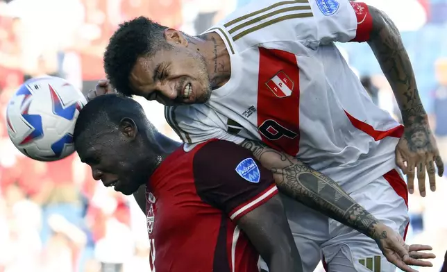 Peru's Paolo Guerrero, right, and Canada's Kamal Miller battle for a header during a Copa America Group A soccer match in Kansas City, Kan., Tuesday, June 25, 2024. (AP Photo/Reed Hoffmann)