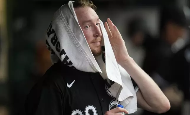 Chicago White Sox starting pitcher Erick Fedde wipes his face in the dugout after the sixth inning of a baseball game against the Cleveland Guardians, Wednesday, July 3, 2024, in Cleveland. (AP Photo/Sue Ogrocki)