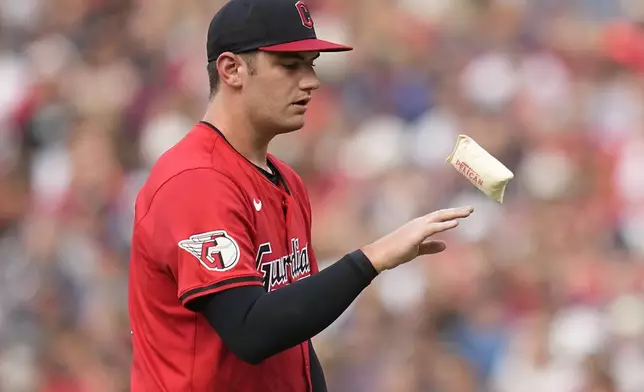 Cleveland Guardians pitcher Gavin Williams tosses the rosin bag in the third inning of a baseball game against the Chicago White Sox, Wednesday, July 3, 2024, in Cleveland. (AP Photo/Sue Ogrocki)