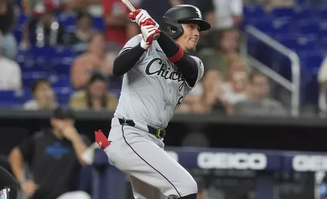 Chicago White Sox second baseman Nicky Lopez (8) hits a double to right field during the second inning of a baseball game against the Miami Marlins, Friday, July 5, 2024, in Miami. Paul DeJong scored on the play. (AP Photo/Marta Lavandier)