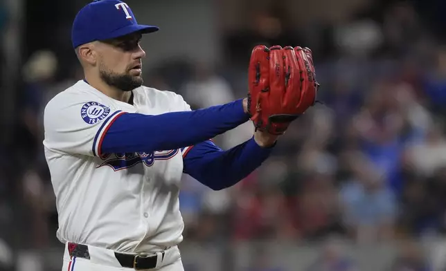 Texas Rangers starting pitcher Nathan Eovaldi prepares to throw during the first inning of a baseball game against the Chicago White Sox in Arlington, Texas, Wednesday, July 24, 2024. (AP Photo/LM Otero)