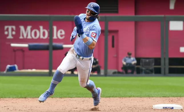 Kansas City Royals' Bobby Witt Jr. sprints to third base on a single by Kansas City Royals' Vinnie Pasquantino during the sixth inning of a baseball game against the Chicago White Sox, Sunday, July 21, 2024, in Kansas City, Mo. (AP Photo/Reed Hoffmann)