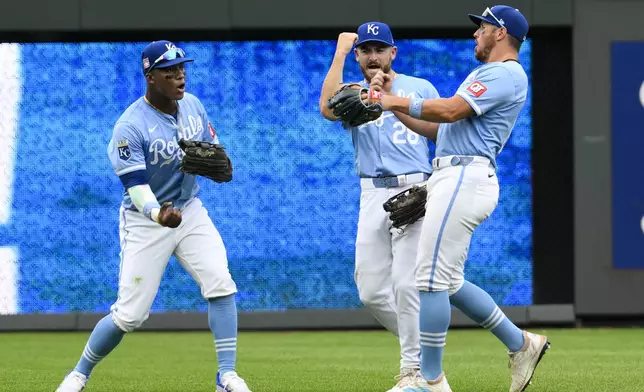 Kansas City Royals left fielder Dairon Blanco, left, center fielder Kyle Isbel (28) and right fielder Hunter Renfroe, right, celebrate after they defeated the Chicago White Sox in a baseball game, Sunday, July 21, 2024, in Kansas City, Mo. (AP Photo/Reed Hoffmann)