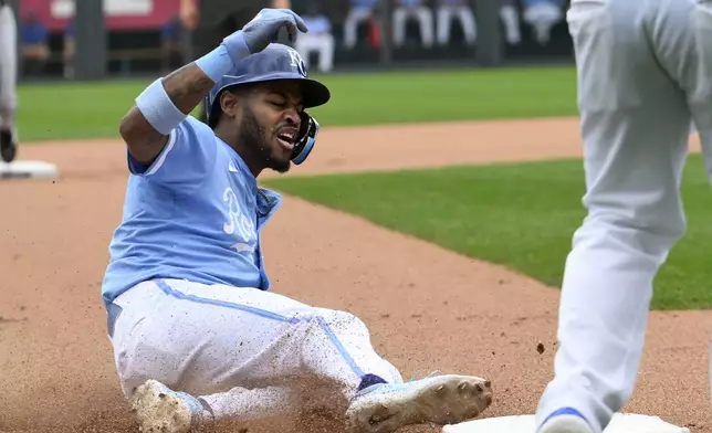 Kansas City Royals' Maikel Garcia slides safely into third base on a single by Kansas City Royals' Dairon Blanco during the seventh inning of a baseball game against the Chicago White Sox, Sunday, July 21, 2024, in Kansas City, Mo. (AP Photo/Reed Hoffmann)