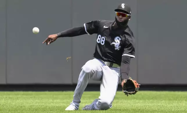 Chicago White Sox center fielder Luis Robert Jr. cannot catch a single off the bat of Kansas City Royals' Bobby Witt Jr. during the first inning of a baseball game, Sunday, July 21, 2024, in Kansas City, Mo. (AP Photo/Reed Hoffmann)