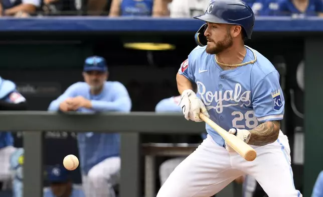 Kansas City Royals' Kyle Isbel puts down a sacrifice bunt to score Kansas City Royals' Maikel Garcia during the seventh inning of a baseball game against the Chicago White Sox, Sunday, July 21, 2024, in Kansas City, Mo. (AP Photo/Reed Hoffmann)