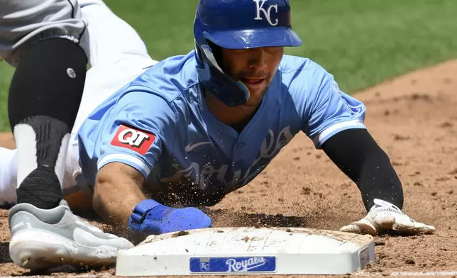 Kansas City Royals' Adam Frazier dives back to first base safely after a Kansas City Royals' Bobby Witt Jr. line drive out during the third inning of a baseball game against the Chicago White Sox, Sunday, July 21, 2024, in Kansas City, Mo. (AP Photo/Reed Hoffmann)