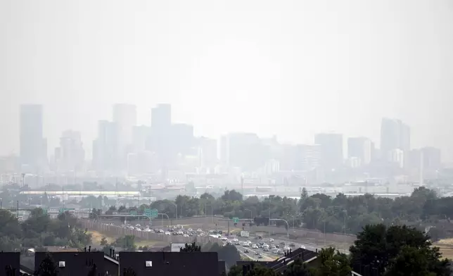 Haze hangs in the air over downtown Denver, Wednesday, July 24, 2024. Fires burning in California, Oregon, Arizona, Washington and other western states, as well as Canada, have filled the skies in regions of the western U.S. with smoke and haze, forcing some affected areas to declare air quality alerts or advisories. (AP Photo/Thomas Peipert)