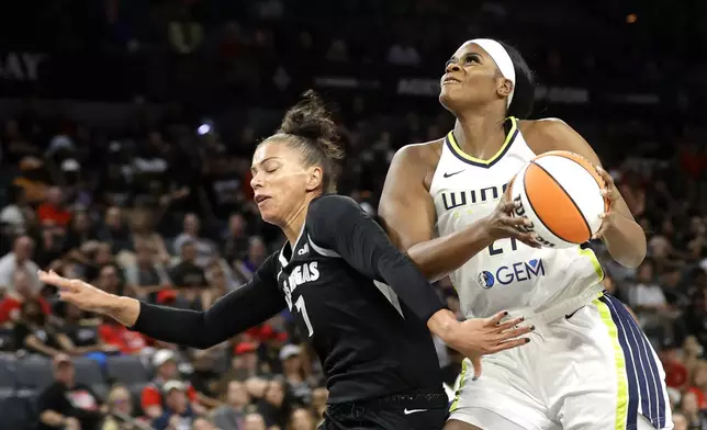 Dallas Wings center Kalani Brown heads to the basket against Las Vegas Aces forward Alysha Clark (7) during the first half of an WNBA basketball game, Sunday, July 7, 2024, in Las Vegas. (Steve Marcus/Las Vegas Sun via AP)