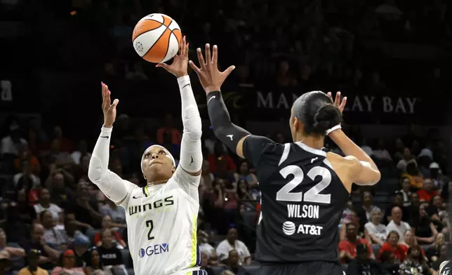 Dallas Wings guard Odyssey Sims (2) shoots over Las Vegas Aces center A'ja Wilson (22) during the first half of a WNBA basketball game Sunday, July 7, 2024, in Las Vegas. (Steve Marcus/Las Vegas Sun via AP)