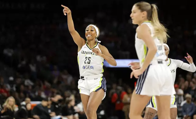 Dallas Wings forward Monique Billings (25) celebrates after scoring a basket against the Las Vegas Aces during the first half of an WNBA basketball game, Sunday, July 7, 2024, in Las Vegas. (Steve Marcus/Las Vegas Sun via AP)