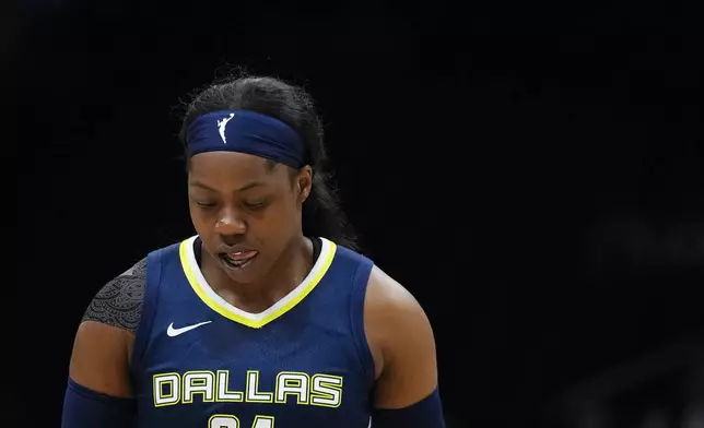 Dallas Wings guard Arike Ogunbowale looks down during a stoppage as her team trails the Seattle Storm during the first half of a WNBA basketball game, Monday, July 1, 2024, in Seattle. (AP Photo/Lindsey Wasson)